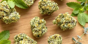 CBD for sinus issues herbal cannabis buds with mint leaves on wooden surface