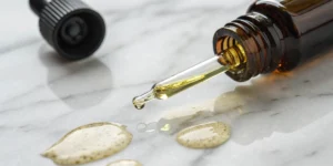 Drop of cannabis sativa seed oil lip oil on marble
